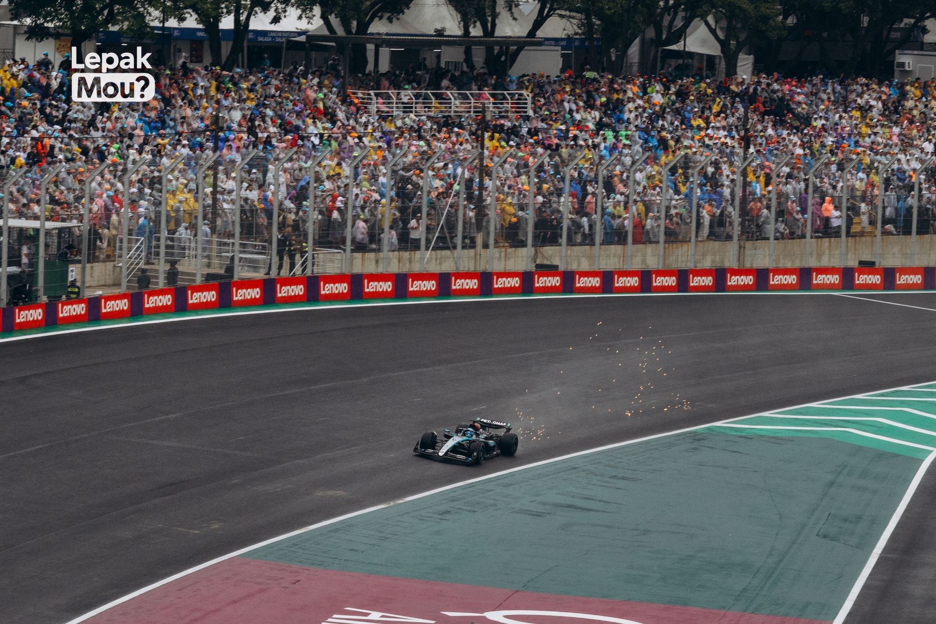 Packed grandstand of fans watching a Formula 1 race