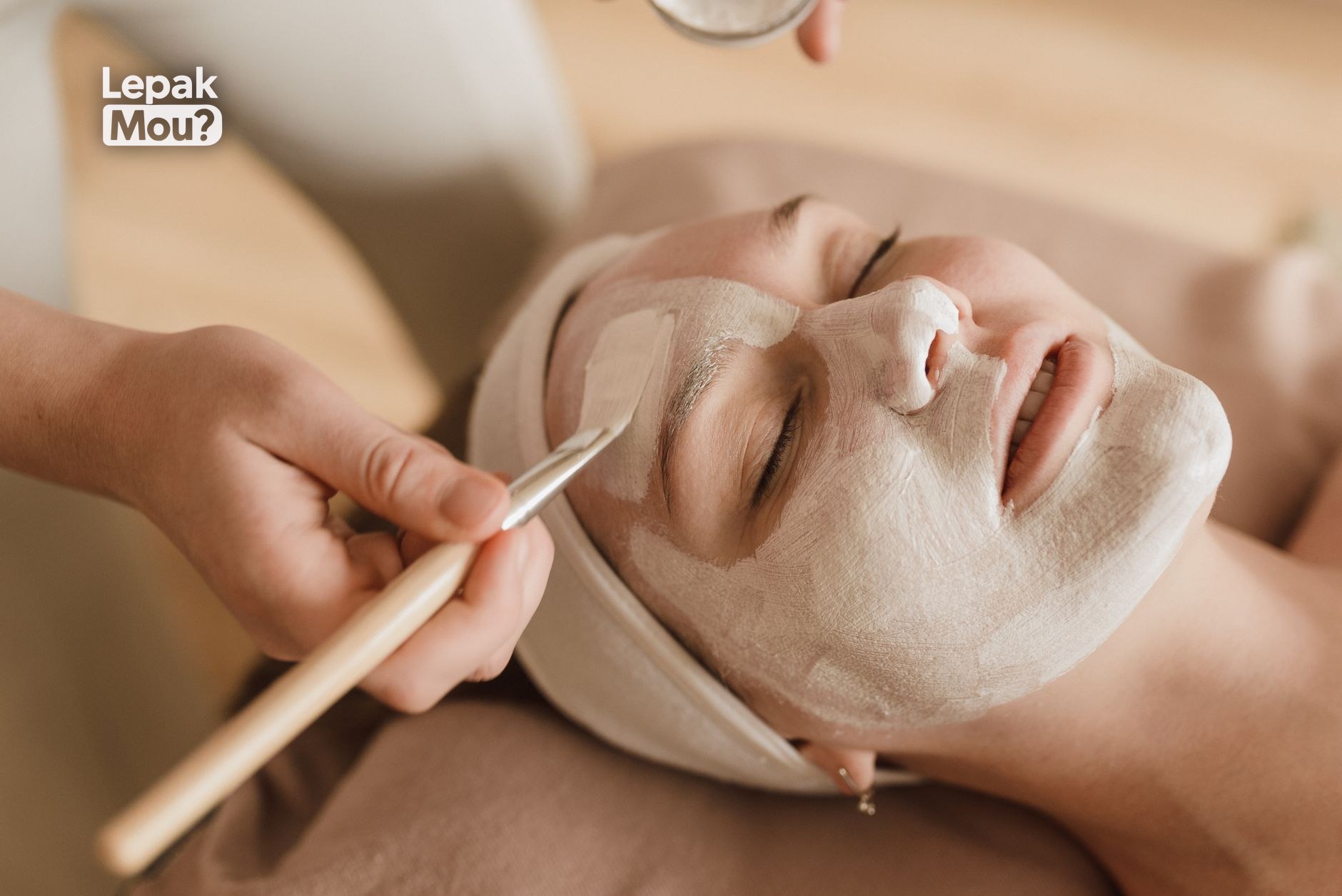 A woman relaxing during a facial with a face mask
