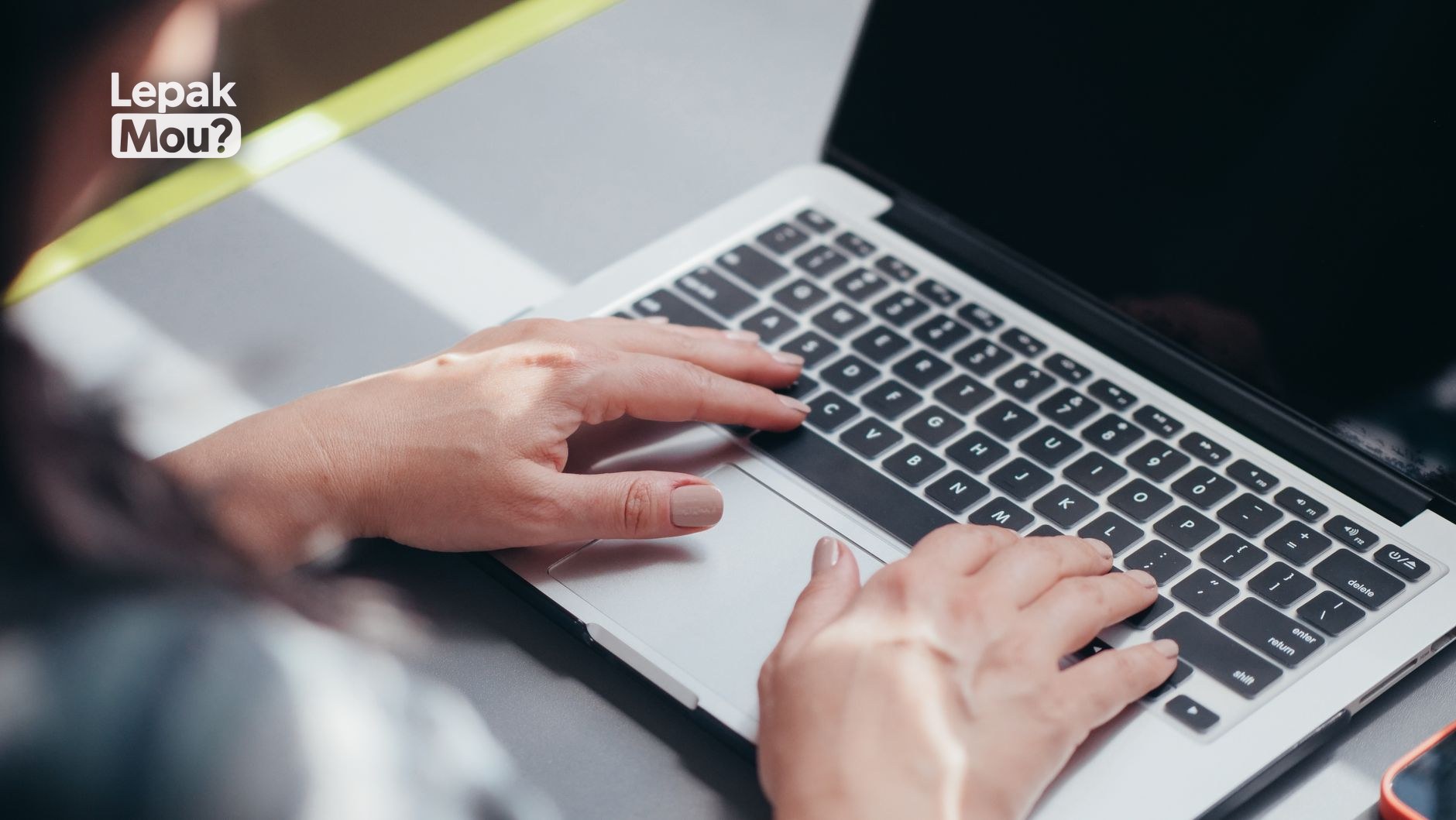 Writing a job rejection email on a laptop